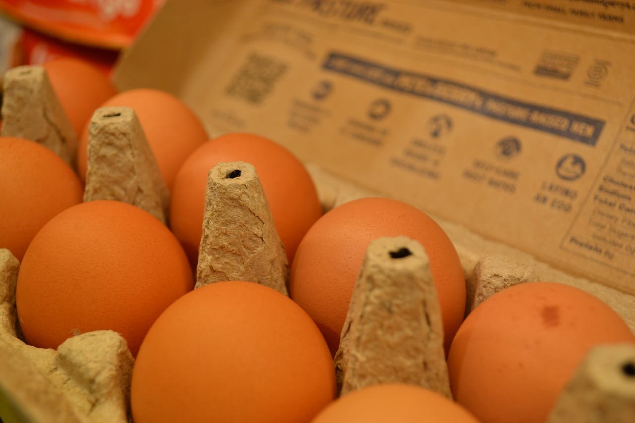 Detail shot of brown eggs in a cardboard carton, perfect for food and grocery themes.